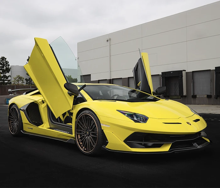 Yellow Lamborghini parked with scissors doors open