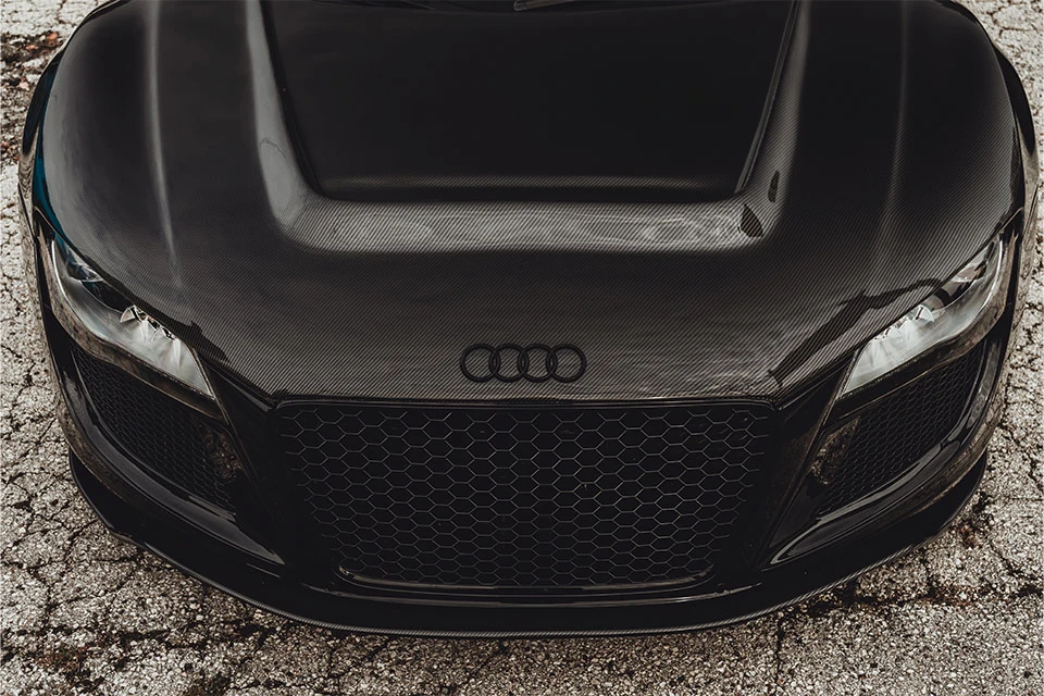 Front of black Audi including the Audi logo