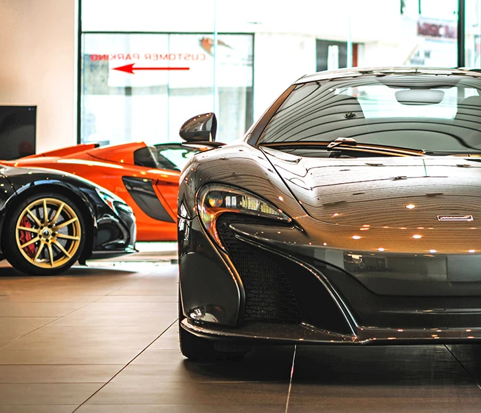 Front view of a black McLaren in a car showroom