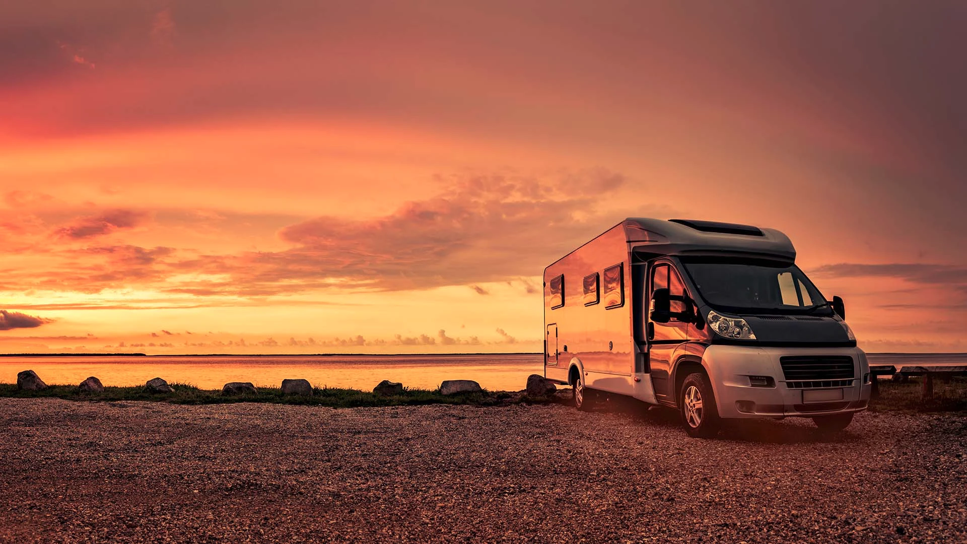 Sunset with a motorhome parked next to the sea