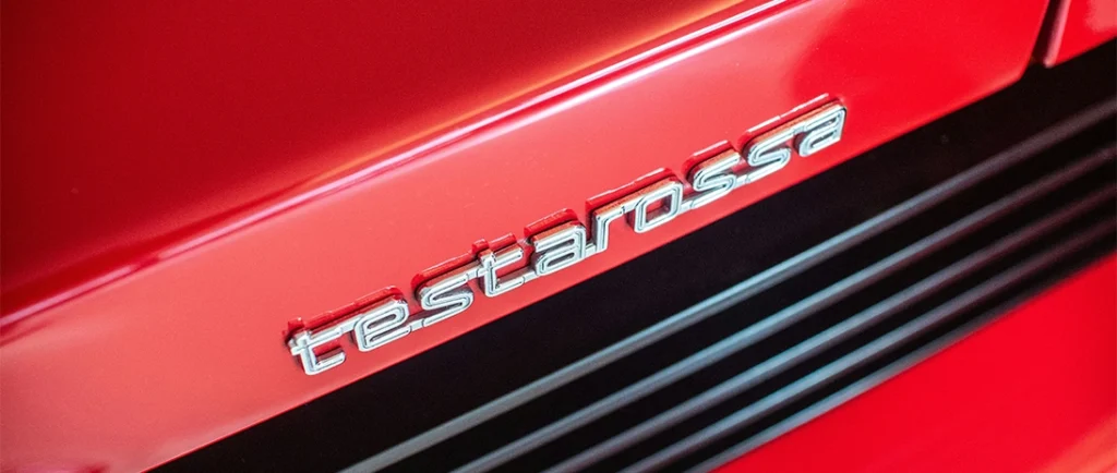 Close up of red Ferrari Testarossa badge