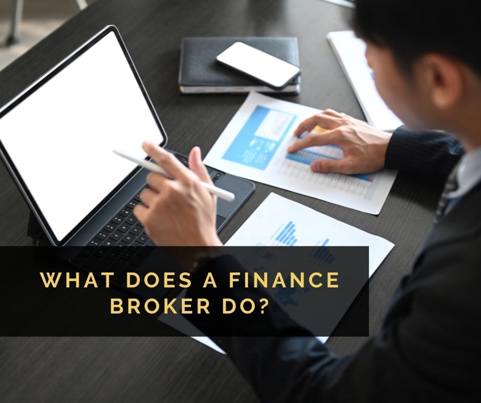 Man sitting at a desk with laptop an papers with the blog post title "What Does a Finance Broker Do" overlaid